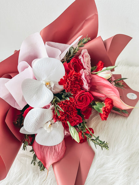 (With Phalaenopsis) Elysia- 12 stalks mixed dark Shocking Pink roses & Red Carnations